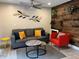 Comfortable living room with a cozy couch, a striking wood-paneled accent wall, and stylish decor at 1122 Spaceport Ct, Kissimmee, FL 34741