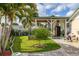 Landscaped backyard featuring an outdoor kitchen, lush grass, garden beds and beautiful plants on a sunny day at 11242 Stone Gate Ct, Orlando, FL 32837