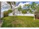 Lush backyard with green lawn, mature trees, and a relaxing hammock at 11242 Stone Gate Ct, Orlando, FL 32837