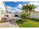 Fenced backyard with lush green lawn, well-maintained landscaping, and a paved walkway leading to the side of the house at 11242 Stone Gate Ct, Orlando, FL 32837