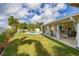 Spacious backyard featuring a refreshing pool, covered patio, and lush landscaping, perfect for outdoor living at 11242 Stone Gate Ct, Orlando, FL 32837
