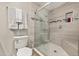 Modern bathroom showcasing a glass-enclosed shower with gray tile and a built-in niche for toiletries at 11242 Stone Gate Ct, Orlando, FL 32837