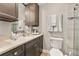 Well-lit bathroom featuring a vanity with dark cabinets, a stone countertop, and decorative elements at 11242 Stone Gate Ct, Orlando, FL 32837