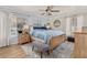 Inviting bedroom with a wooden bed frame, blue bedding, ceiling fan, and view of the pool at 11242 Stone Gate Ct, Orlando, FL 32837