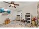 Bright bedroom featuring a ceiling fan, closet, and a comfortable armchair at 11242 Stone Gate Ct, Orlando, FL 32837