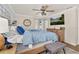 Comfortable bedroom features a wooden bed frame, blue bedding, ceiling fan, and dresser at 11242 Stone Gate Ct, Orlando, FL 32837