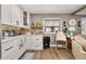 Charming kitchen with white cabinets, open shelving, and warm wood accents at 11242 Stone Gate Ct, Orlando, FL 32837