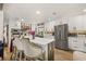 Spacious kitchen with white cabinets, an island with seating, and modern appliances at 11242 Stone Gate Ct, Orlando, FL 32837