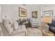 Sitting room featuring cozy chairs and decor, with views to the kitchen at 11242 Stone Gate Ct, Orlando, FL 32837