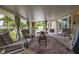 Inviting covered patio featuring comfortable seating, a decorative rug, and serene views of the backyard and pool at 11242 Stone Gate Ct, Orlando, FL 32837