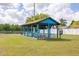 Community picnic pavilion with tables and benches, creating an inviting space for outdoor gatherings at 11242 Stone Gate Ct, Orlando, FL 32837