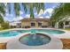 Inviting backyard pool and spa with fountain and landscaped surroundings at 11242 Stone Gate Ct, Orlando, FL 32837