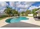 Resort-style pool with a built-in spa, surrounded by lush landscaping and palm trees at 11242 Stone Gate Ct, Orlando, FL 32837