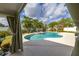 Beautiful backyard pool and spa framed by palm trees and lush landscaping, offering a private oasis at 11242 Stone Gate Ct, Orlando, FL 32837