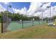 Enjoy the outdoor, fenced tennis courts; perfect for an active lifestyle within the community at 11242 Stone Gate Ct, Orlando, FL 32837