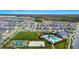 Gorgeous aerial view of the community featuring a pool, playground, sports courts, and well-maintained lawns at 11456 Rhyme Ave, Orlando, FL 32832