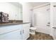 Bright bathroom includes a single sink vanity with a gray countertop and a shower-tub at 11456 Rhyme Ave, Orlando, FL 32832