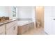 Bathroom featuring double vanity, soaking tub, and toilet room at 11456 Rhyme Ave, Orlando, FL 32832