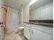 Bright bathroom featuring white fixtures, gray countertop, and shower/tub combo with modern hardware at 11456 Rhyme Ave, Orlando, FL 32832