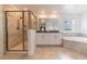 Spacious bathroom featuring a glass shower, double vanity, and soaking tub with a window view at 11456 Rhyme Ave, Orlando, FL 32832
