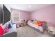 bedroom features fun decor, a toy shelf, and a large window at 11456 Rhyme Ave, Orlando, FL 32832