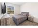 Minimalist bedroom with a comfortable bed, neutral colors, and a mounted television at 11456 Rhyme Ave, Orlando, FL 32832