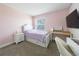 Charming bedroom features a cozy bed, a desk, and a large window at 11456 Rhyme Ave, Orlando, FL 32832