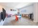 Upstairs bonus room is perfect for play or work with television, desk, and natural light at 11456 Rhyme Ave, Orlando, FL 32832