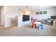 Upstairs bonus room is perfect for play or work with television, desk, and natural light at 11456 Rhyme Ave, Orlando, FL 32832