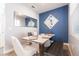 Stylish dining area features a modern table, trendy seating, and an eye-catching blue accent wall at 11456 Rhyme Ave, Orlando, FL 32832