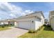 Exterior view of the home's two-car garage with brick-paved driveway at 11456 Rhyme Ave, Orlando, FL 32832