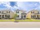 Inviting two-story house with a quaint front porch, enhanced by lush landscaping and a vibrant green lawn at 11456 Rhyme Ave, Orlando, FL 32832