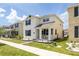 Stylish two-story residence featuring a covered porch and meticulously landscaped surroundings at 11456 Rhyme Ave, Orlando, FL 32832