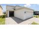 Side view of the house with lanai and a two-car garage at 11456 Rhyme Ave, Orlando, FL 32832