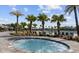 Relaxing hot tub surrounded by palm trees and lounge chairs in a serene community setting at 11456 Rhyme Ave, Orlando, FL 32832