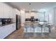 Modern kitchen with stainless steel appliances, white cabinets, and a central island with barstool seating at 11456 Rhyme Ave, Orlando, FL 32832
