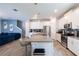 Open-concept kitchen with an island, white cabinets, stainless steel appliances, and modern lighting at 11456 Rhyme Ave, Orlando, FL 32832