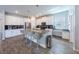 Spacious kitchen with white cabinetry, stainless steel appliances, an island with seating, and stylish tile flooring at 11456 Rhyme Ave, Orlando, FL 32832