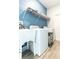 This home includes a convenient laundry room with modern washer, dryer, sink, and ample shelving at 11456 Rhyme Ave, Orlando, FL 32832