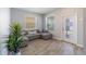 Cozy living room with tile floors, natural lighting, and a comfortable sectional sofa at 11456 Rhyme Ave, Orlando, FL 32832