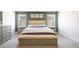 Large main bedroom with bench seating and bedside tables at 11456 Rhyme Ave, Orlando, FL 32832