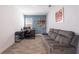 Office space with a work desk, grey sofa, decor shelving, and neutral paint at 11456 Rhyme Ave, Orlando, FL 32832