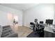 Office space with a work desk, grey sofa, and an open doorway at 11456 Rhyme Ave, Orlando, FL 32832