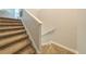 Carpeted stairway with white banister and trim, ascending to the upper level of the home at 11456 Rhyme Ave, Orlando, FL 32832