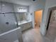 Luxurious bathroom with marble tile, double vanity, and glass enclosed shower at 1400 Fair Oaks Ave, Kissimmee, FL 34744