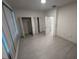 Bedroom with multiple closets and tile flooring, offering ample storage space at 1400 Fair Oaks Ave, Kissimmee, FL 34744