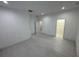 Bright bedroom with neutral walls, tile flooring, and access to a walk-in closet and other rooms at 1400 Fair Oaks Ave, Kissimmee, FL 34744