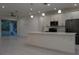 Open-concept kitchen featuring a spacious island, modern appliances, sleek white cabinetry and an adjacent dining area at 1400 Fair Oaks Ave, Kissimmee, FL 34744