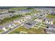 An aerial shot of a community with various homes, green spaces, and a pond at 1507 Bitteroot St, Kissimmee, FL 34744