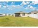 Large backyard featuring a screened-in porch and a well-maintained lawn at 1507 Bitteroot St, Kissimmee, FL 34744
